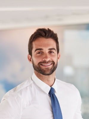 portrait of a confident young businessman standing in an office portrait of a confident young businessman standing in an office