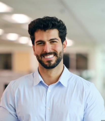 a man standing in a company office. a man standing in a company office.